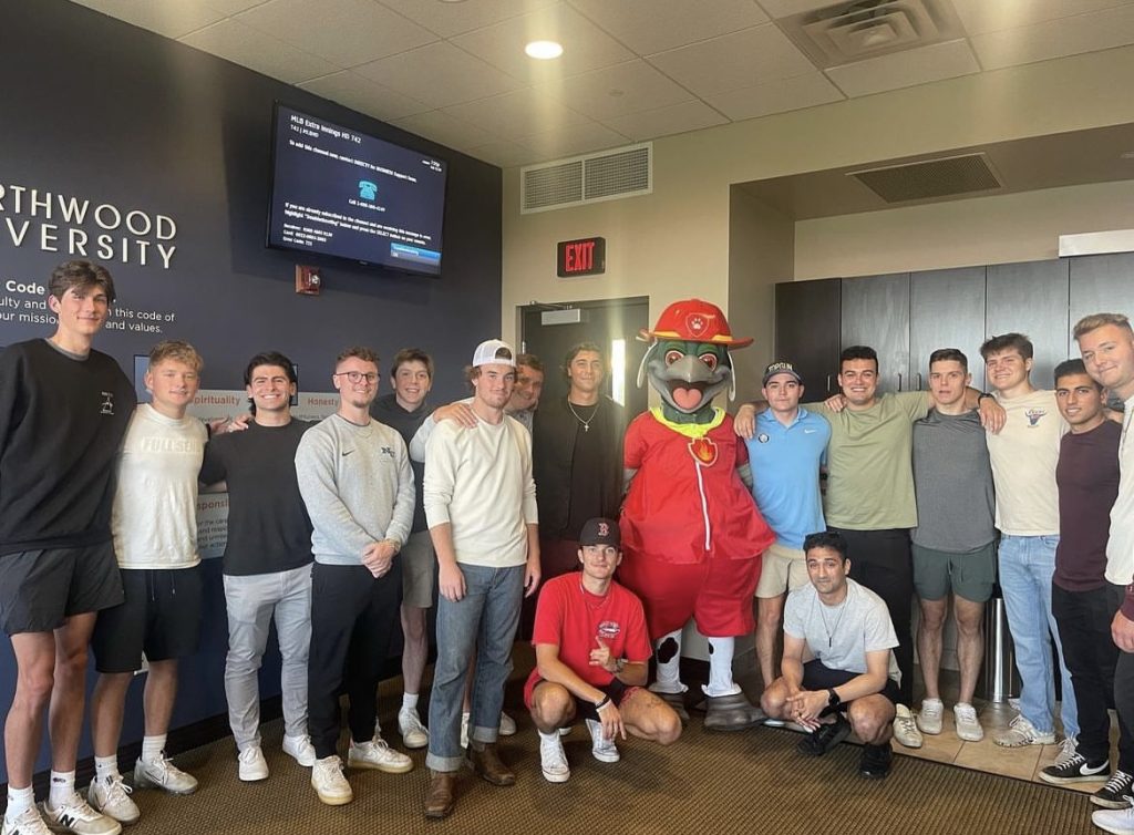 Alpha Sigma brothers pictured with Louie the Loon