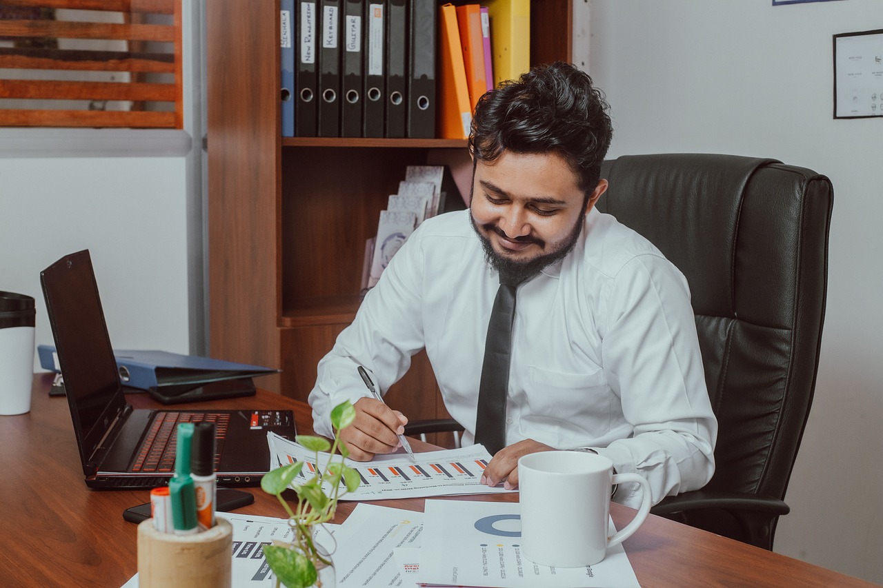 Business man looking at papers on his desk.