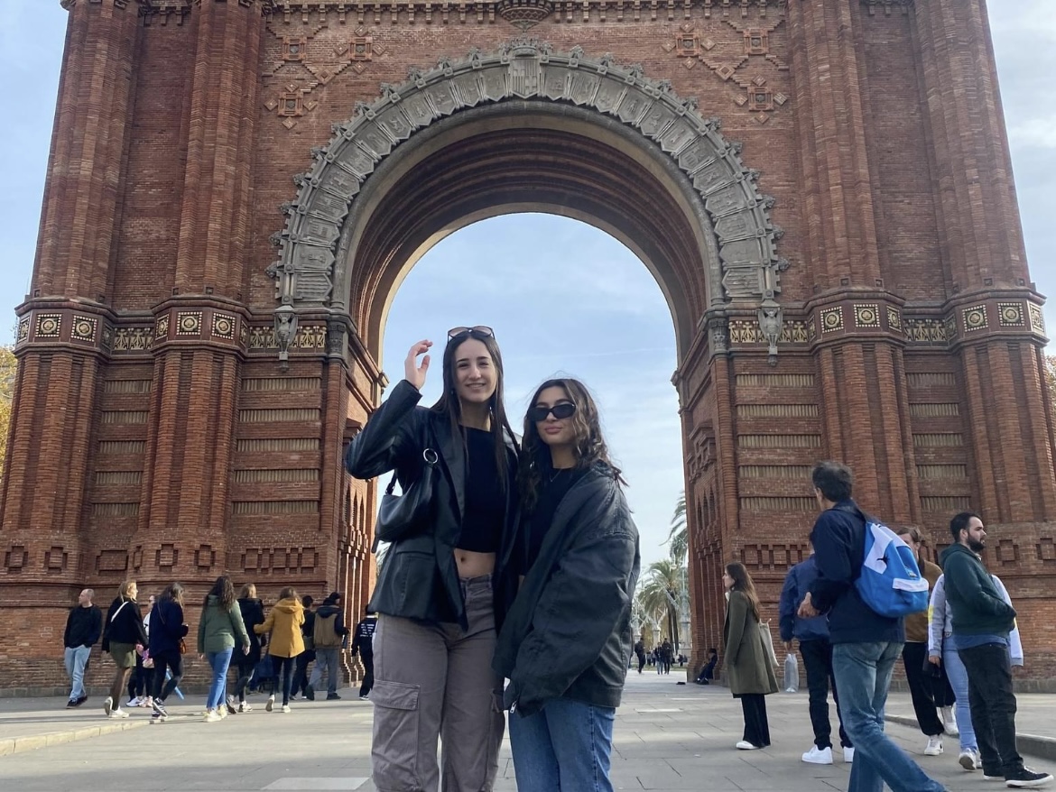 Two students posing in front of a European landmark