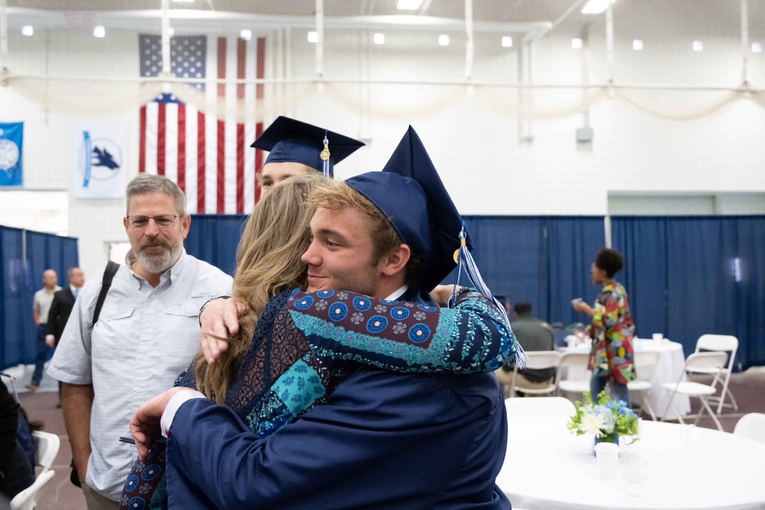 Parent hugging their student at graduation