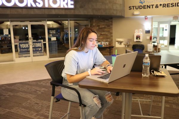 Student working on her laptop in the Bookstore