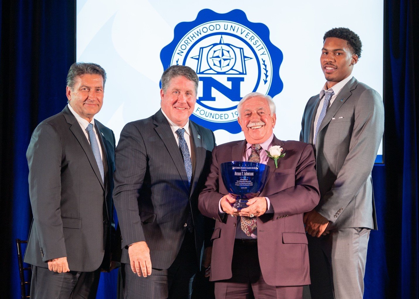  From left, Northwood University Board of Trustees Vice Chair Steve Madincea; President Kent MacDonald; 2022 OBL Michael T. Lafontaine Sr.; and DeSean Munson, a student who introduced Lafontaine. 