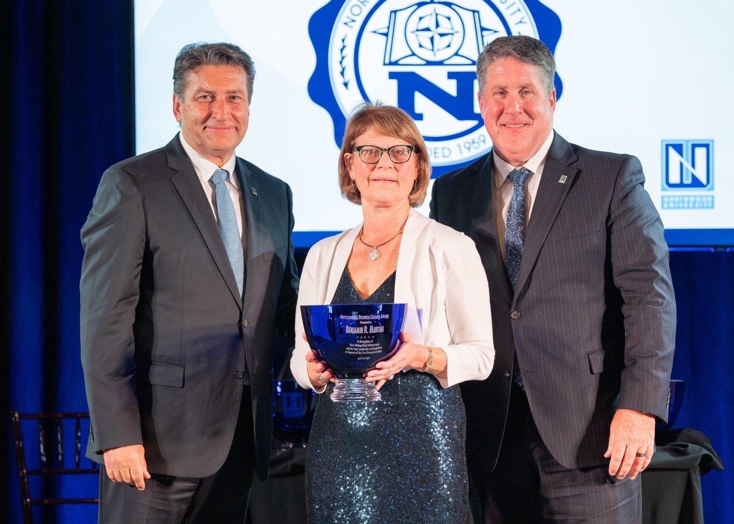  From left, Northwood University Board of Trustees Vice Chair Steve Madincea; Dolores Porte, Sanford Village President and student in the Richard DeVos Graduate School at Northwood University; and President Kent MacDonald. Porte accepted the award on