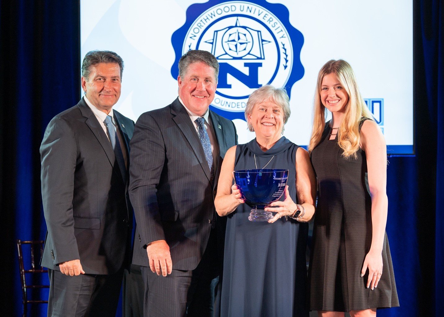  From left, Northwood University Board of Trustees Vice Chair Steve Madincea; President Kent MacDonald; Carol Williams, a former OBL who accepted this year’s award on behalf of 2022 OBL Jim Fitterling; and Kennedy Hatfield, a student who introduced W
