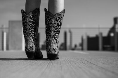 Girl wearing cowboy boots in black and white