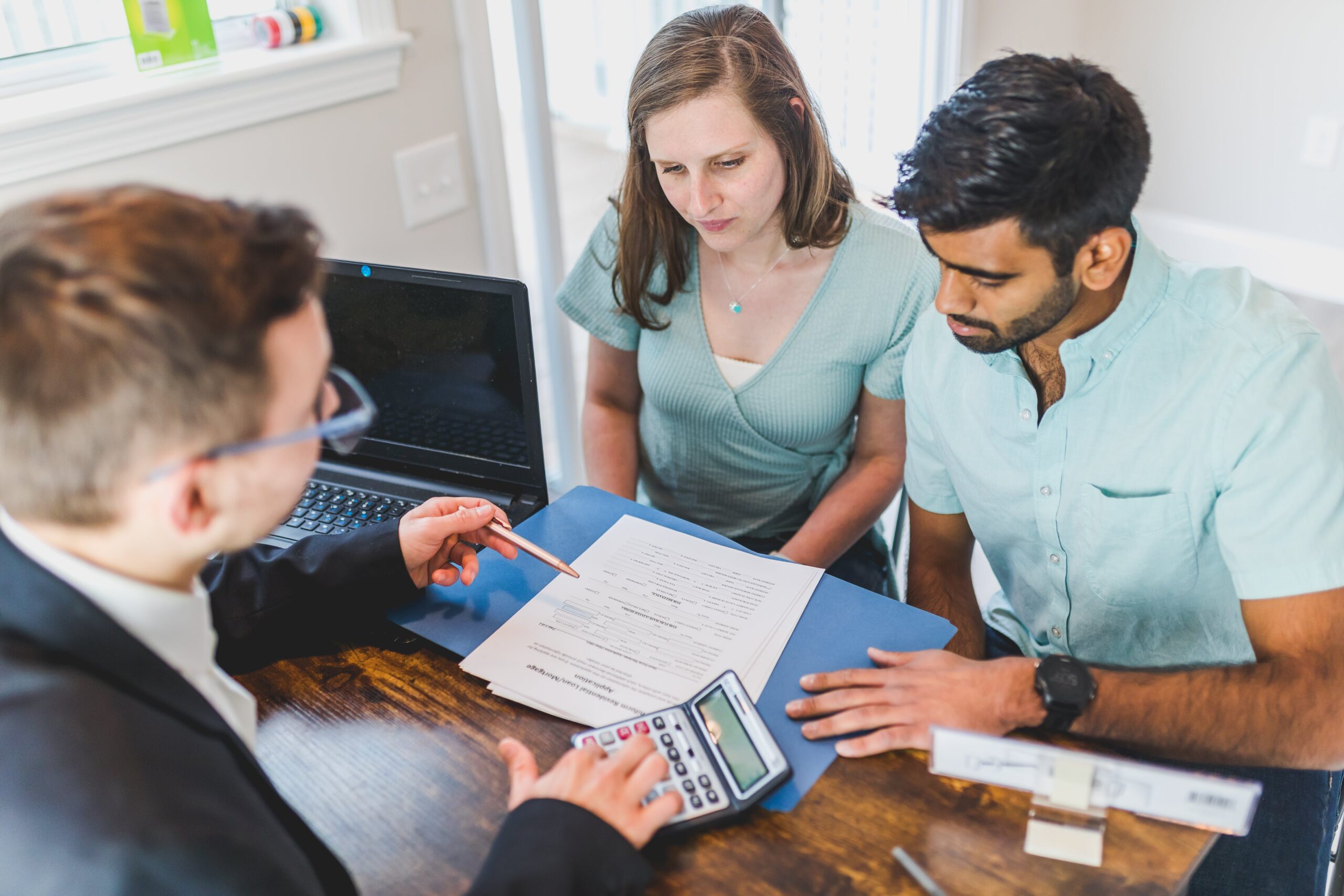 Sales representative looking over a document with a family