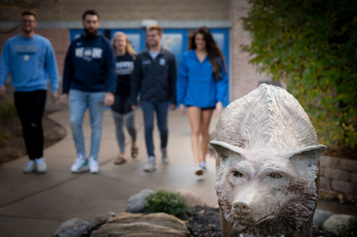 Timberwolf statue with Northwood students in the background