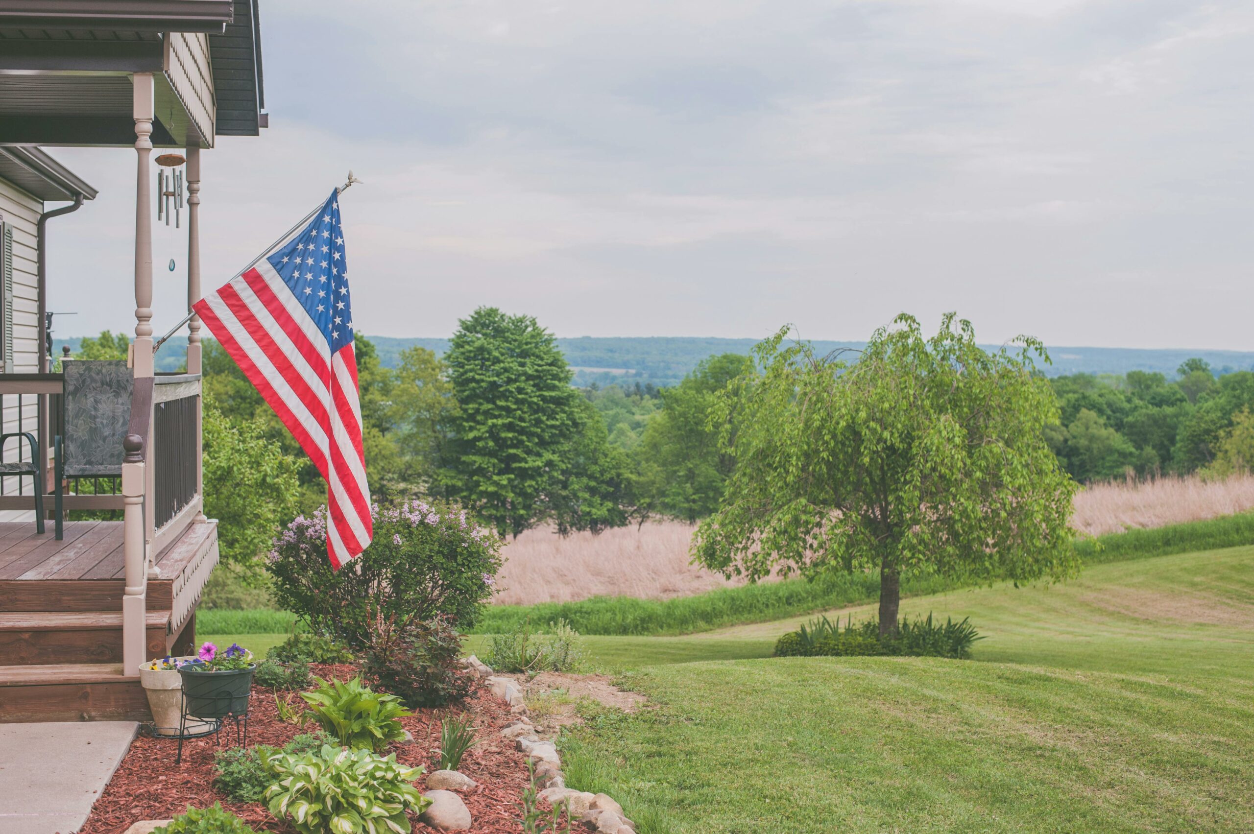 American flag on the porch in a country setting