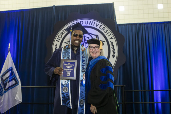Northwood graduate receiving honors and smiling with the Academic Dean